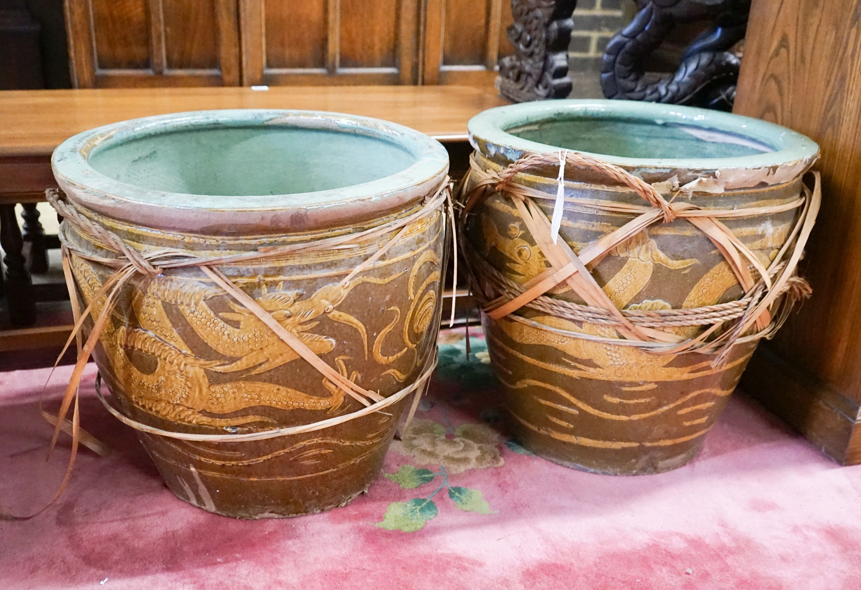 A pair of Chinese glazed earthenware dragon planters, diameter 50cm, height 47cm